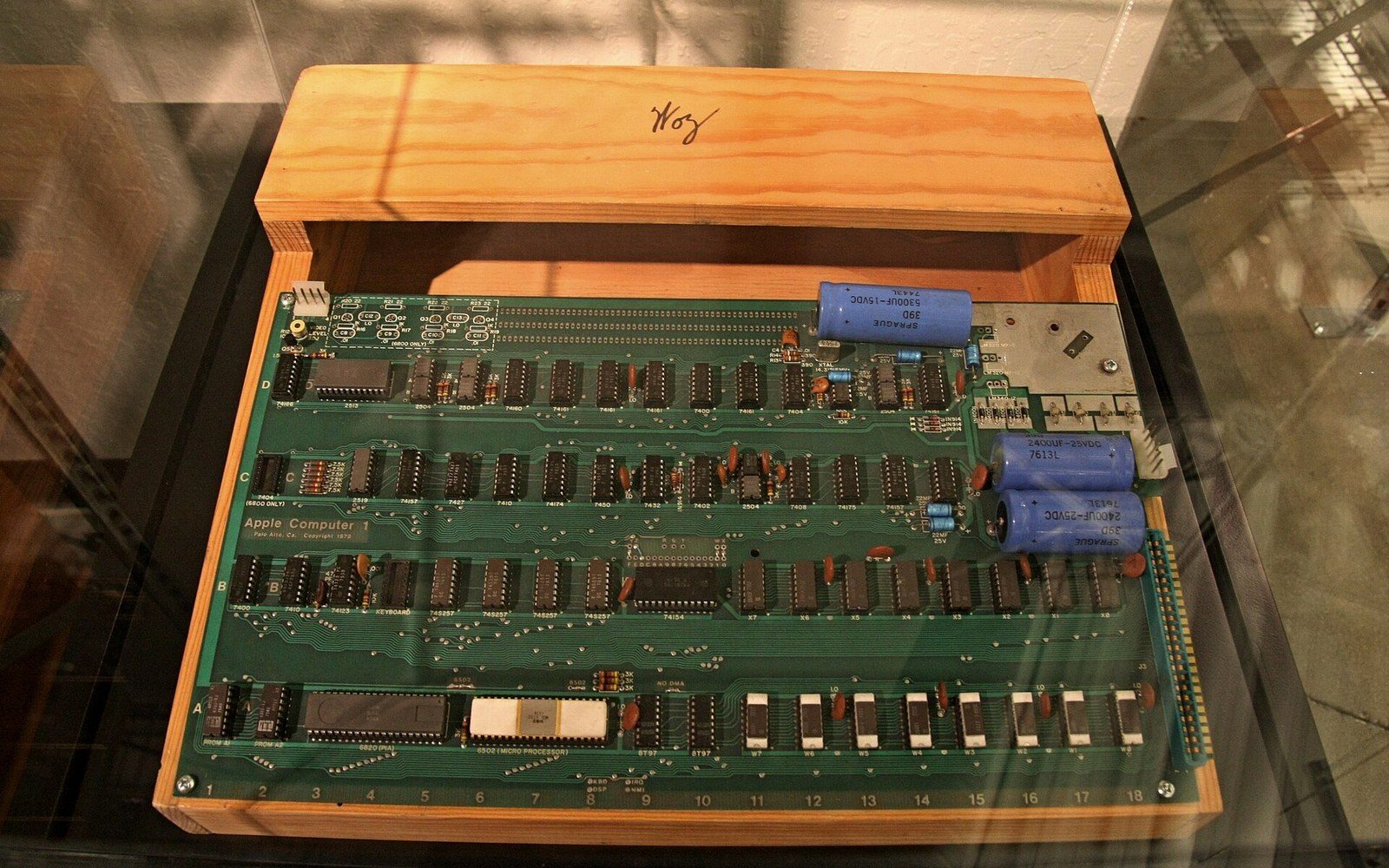 Apple I circuit board held in a hand, 1976 hardware visible