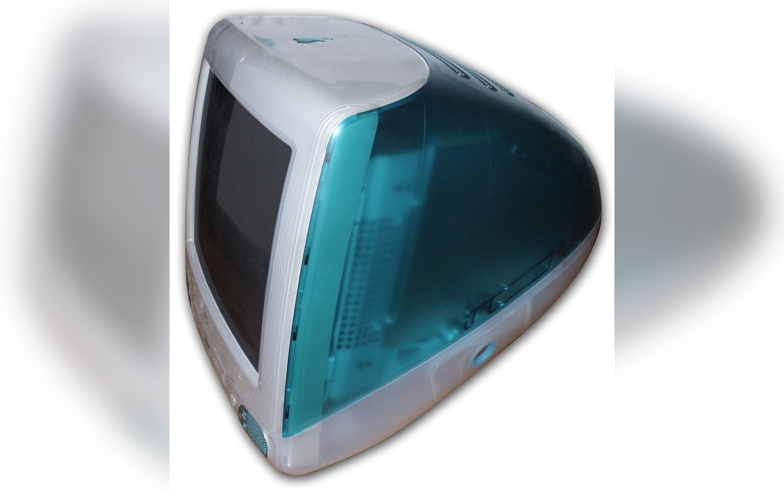 Translucent bondi blue iMac G3 shown at an angle against a plain background