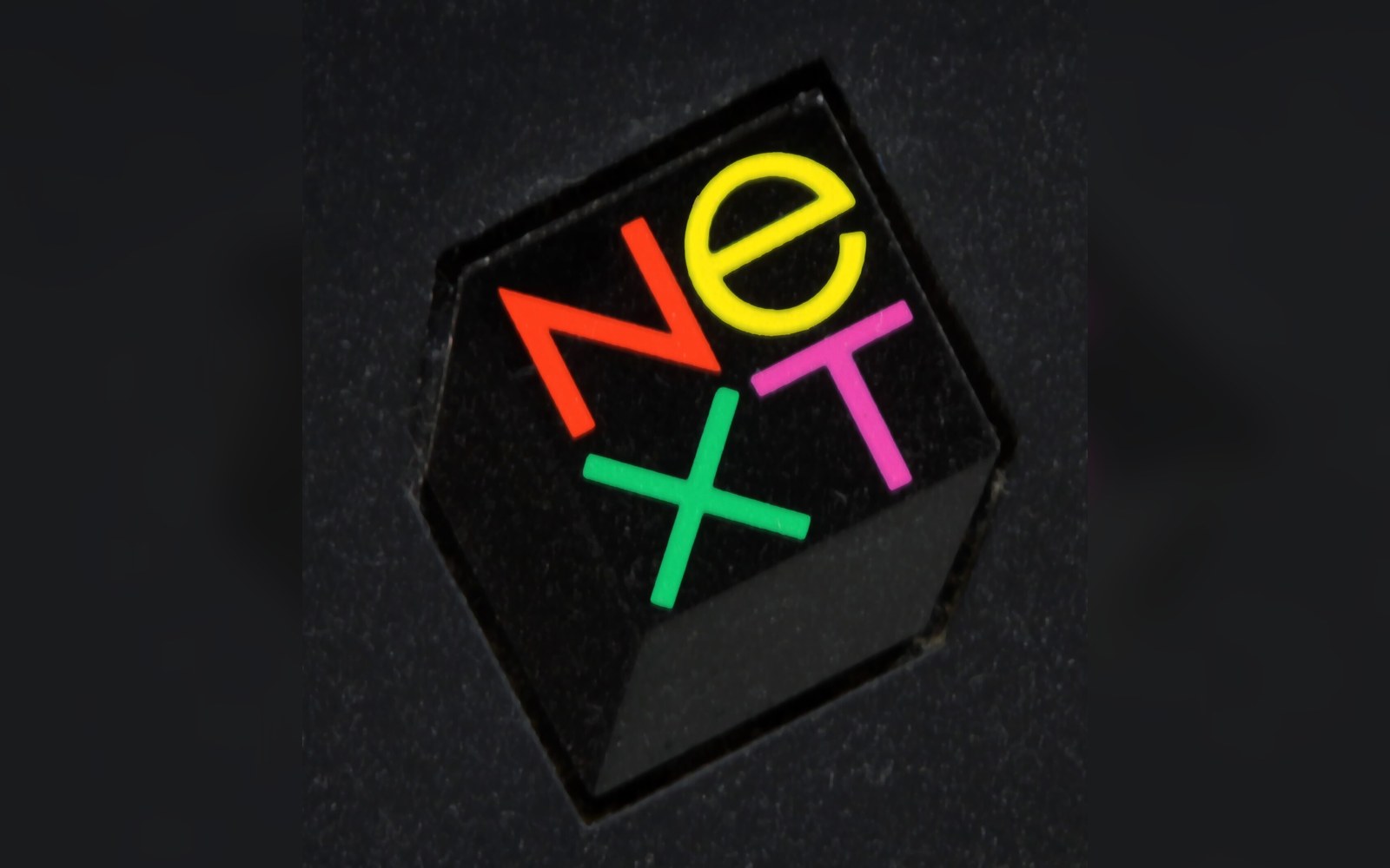 The colorful NeXT logo displayed on the black cube of a NeXTstation computer